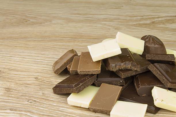 istock Pieces of chocolate on a wooden board. 481111226