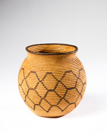 Antique Chemehuevi Indian olla basket on a white background.