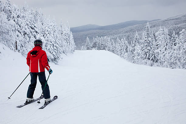 Mont Tremblant, Canada - February 9, 2014:  A lonely skier is sliding down an easy slope at Mont-Tremblant.  Mont-Tremblant Ski Resort is acknowledged by most industry experts as being the best ski resort in Eastern North America.