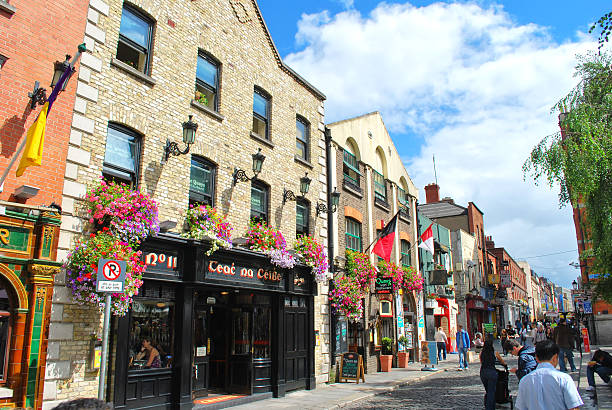 Dublin, Ireland - August 2, 2008: View of Temple Bar, the most famous part of Dublin for the pub, during a sunny day with people walking