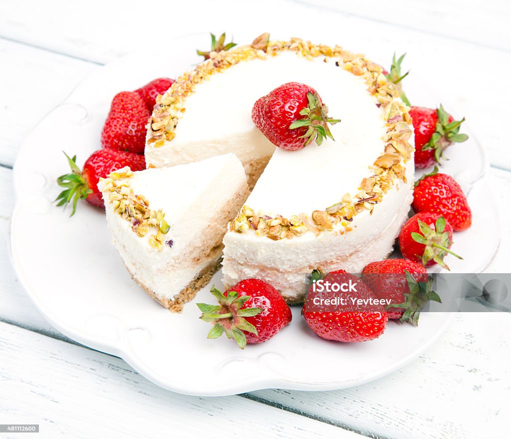 cheese cake with strawberries cheese cake with strawberries on a wooden white table 2015 Stock Photo