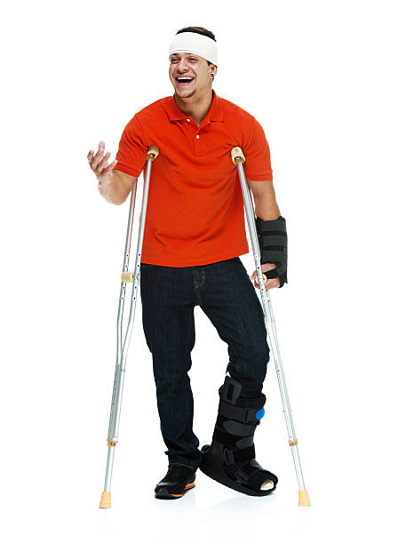 istock Smiling man standing with crutches and looking away 481113467