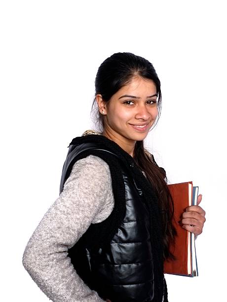Smiling Ukrainian university student leaning against building glass wall