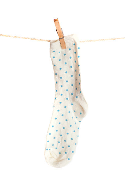 istock white socks with blue spots, hanging from a rope 481114531