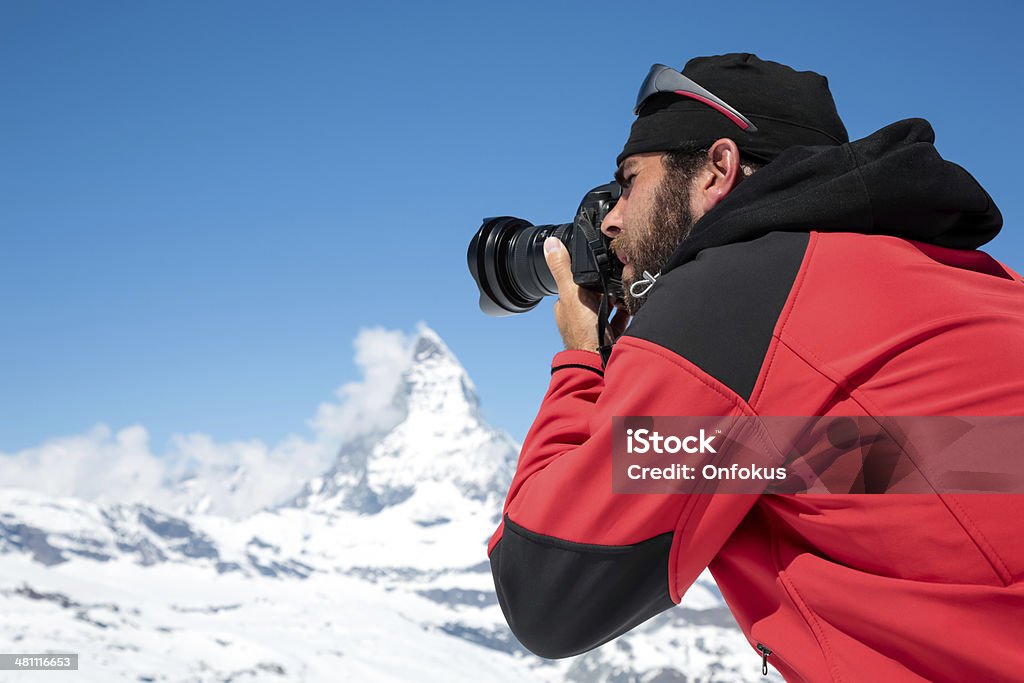 Man Photographer Taking Picture with DSLR Camera of Matterhorn, Switzerland Photographer at Matterhorn, Switzwerland Nature Stock Photo