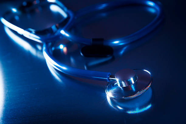 istock Medical stethoscope dramatically lit on a metalic table 481121263