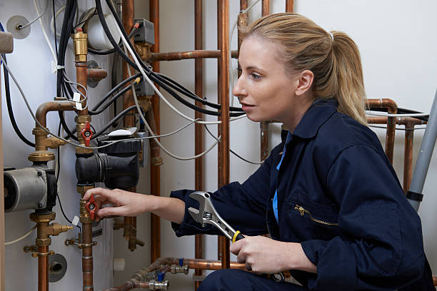 istock Female Plumber Working On Central Heating Boiler 481122820