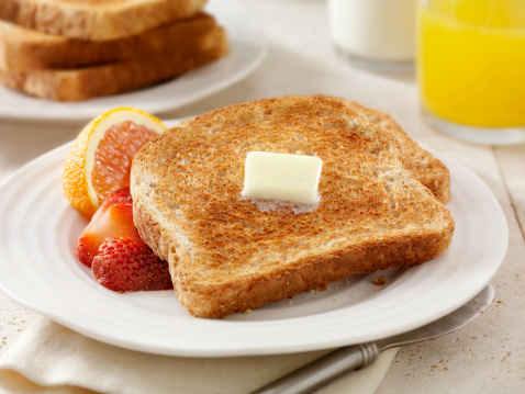 Whole Wheat Toast with Melting Butter, Fresh Fruit, Milk and Orange Juice- Photographed on Hasselblad H3D2-39mb Camera
