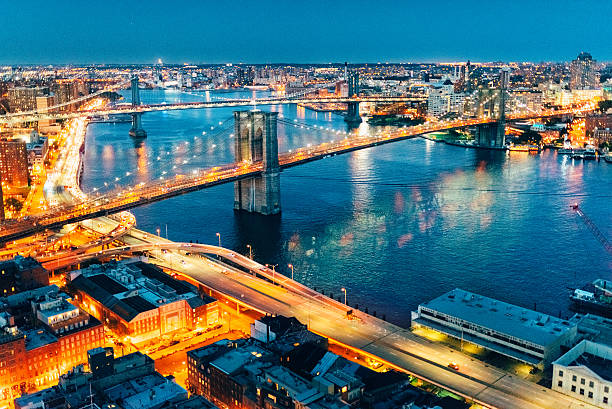 New York City Brooklyn Bridge and Manhattan Bridge Aerial view New York City Aerial View at Dusk from Downtown with views of Brooklyn Bridge and Manhattan bridge. williamsburg bridge stock pictures, royalty-free photos & images