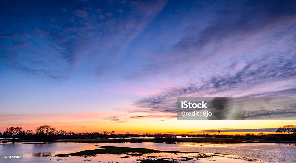 Winter sunset over floodplains of the river IJssel High water levels during a sunset in the floodplains of the river IJssel in Overijssel, The Netherlands during a cold winter sunset. 2015 Stock Photo