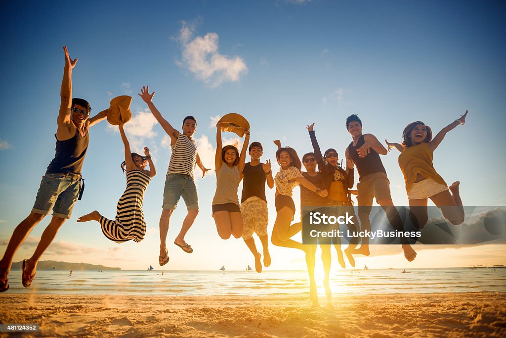 Group of young people jumping Group of young people jumping on beach Group Of People Stock Photo