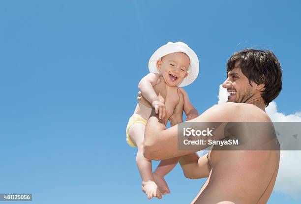 Father And Son Playing On The Beach Stock Photo - Download Image Now - Baby - Human Age, Beach, Diaper