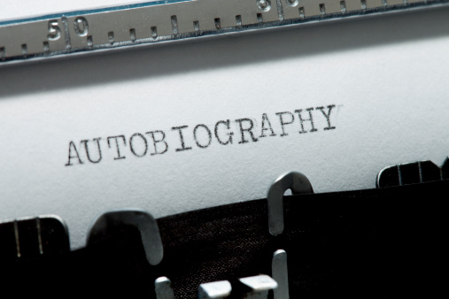 Close up on a retro typewriter with the words 'Autobiography' typed on white paper.