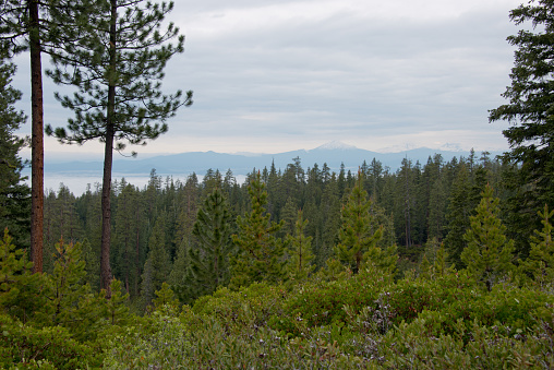 Newberry National Volcanic Monument. Scenic view over some snow-capped mountain peaks (probably Mount Bachelor and South Sister) and fog in the valleys