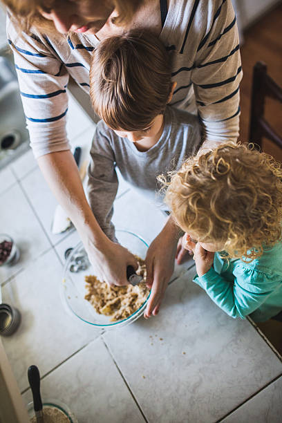 istock Children Baking Cookies with Mom 481129336
