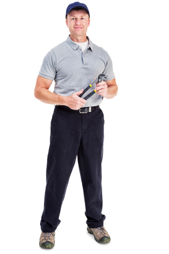 Photo of a handyman holding a pair of channel lock plyers; isolated on white.
