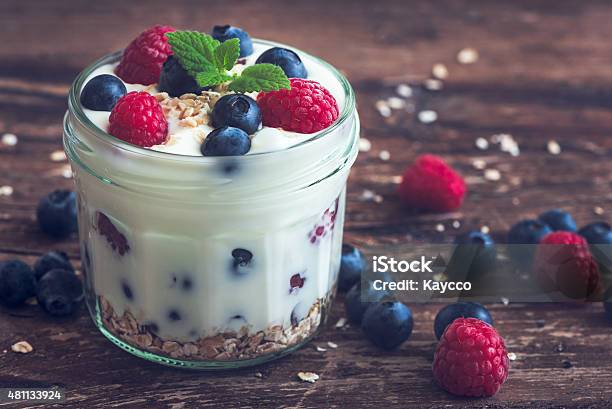 Yoghurt With Fresh Berries On Woden Table Stock Photo - Download Image Now - Food, Red, Blue