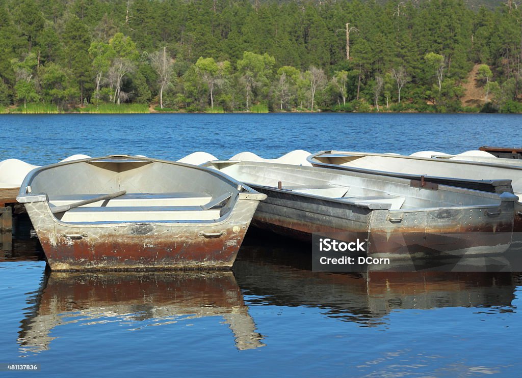 Row Boats Row boat tied to a dock  in  a lake  2015 Stock Photo