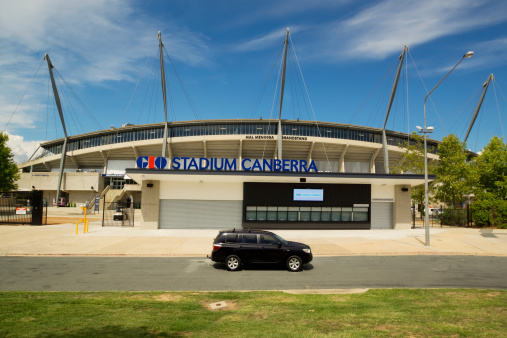 Canberra, Australia - March 14, 2014: A car drives past ticket booths at the entrance to GIO Stadium Canberra (formerly Canberra Stadium). The stadium is primarily used for rugby games and is home to NRL team Canberra Raiders.