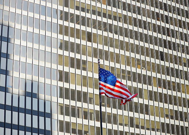 istock USA flag with skyscraper on background 481140594