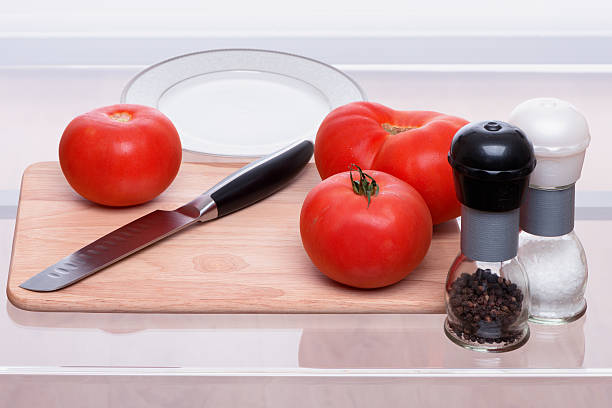 istock Tomatoes and knife on a chopping board 481142136