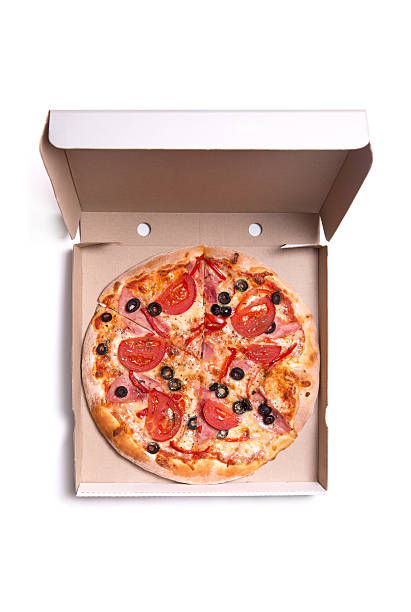 Tasty pizza with ham and tomatoes in box stock photo