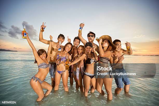 Group Of Friends Having Fun On Summer Beach Stock Photo - Download Image Now - 2015, Adult, Beach