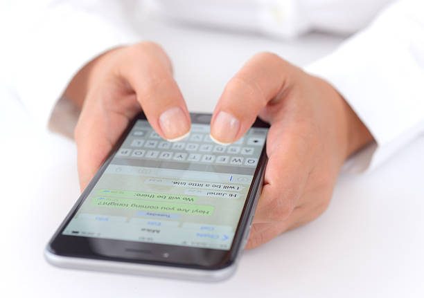 Whatsapp İstanbul, Turkey - July 14, 2015: Hands holding a iPhone 6 Plus displaying WhatsApp messaging application. iPhone is a touchscreen smart phone produced by Apple Inc. apple computers photos stock pictures, royalty-free photos & images