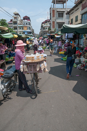 Phnom Penh, Cambodia - April 4, 2012: Shoppers and vendors at a busy street market in Phnom Penh, Cambodia.