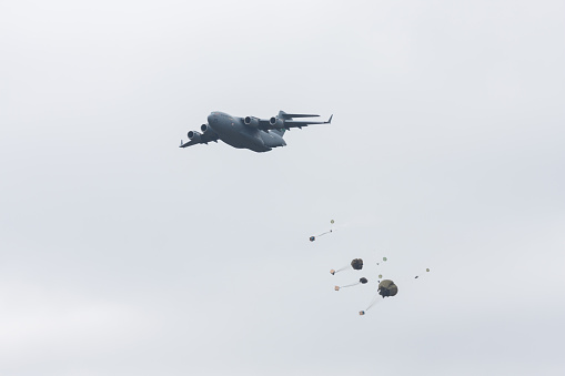 Lakewood, United States - July 17, 2010: Joint Base Lewis-McChord opens its gates to the public for a free airshow every few years.  This image shows a C-17 cargo plane dropping paratroopers.