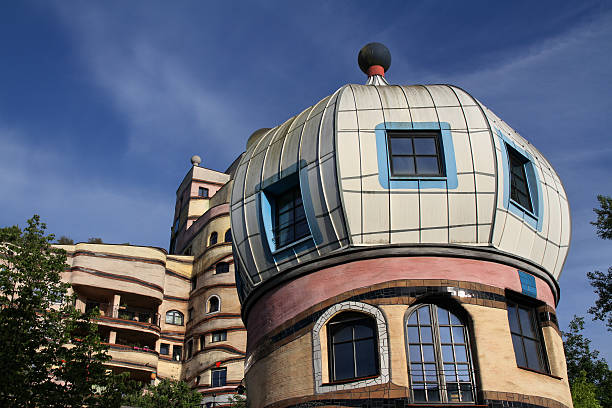Darmstadt, Germany - May 19, 2015: View of the Forest Spiral, Darmstadt, Germany. The Waldspirale is a residential building complex in Darmstadt, Germany, built in the 1990s. The name translates into English as forest spiral, reflecting both the general plan of the building and the fact that it has a green roof. It was designed by Austrian artist Friedensreich Hundertwasser, planned and implemented by architect Heinz M. Springmann, and constructed by the Bauverein Darmstadt company. The building was completed in 2000.