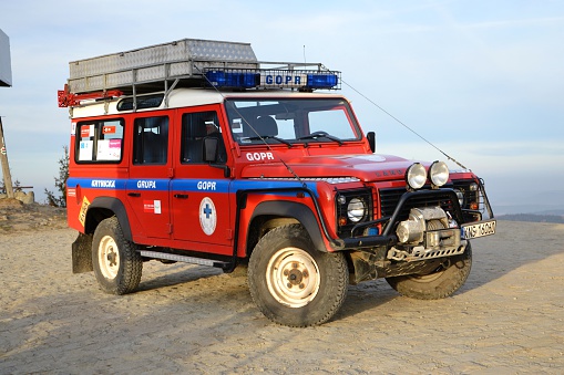 Krynica, Poland - November 17th, 2011: Land Rover Defender with mountain rescue service stopped on the unmade road. This vehicle is used to get in extremely hard areas in the mountains.