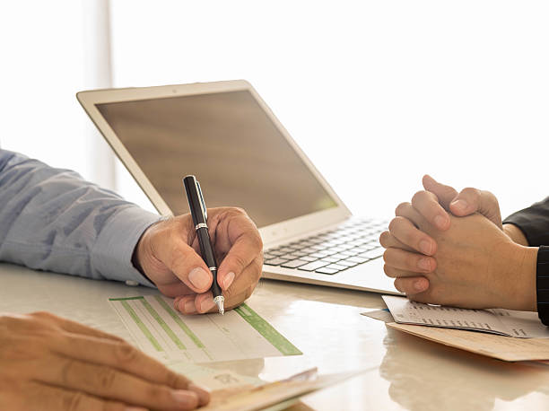 Financial Transactions Businessman is writing a deposit slip. exchange teller stock pictures, royalty-free photos & images