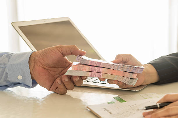 loan Business loan from a bank employee. finance concept exchange teller stock pictures, royalty-free photos & images