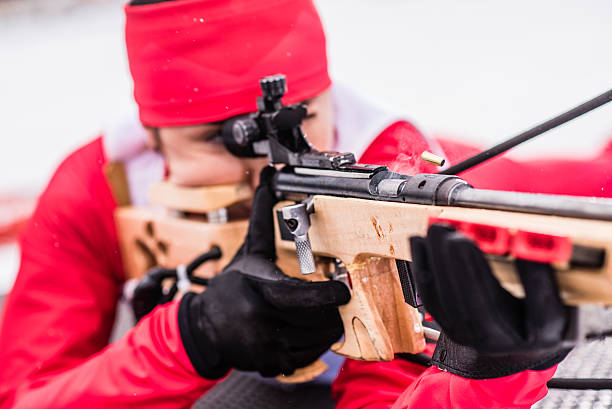 istock Athletic woman with biathlon rifle 481170096