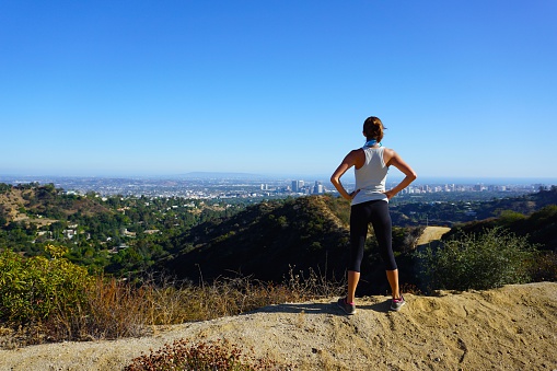 Beautiful Woman overlooking Los Angeles from a local hiking trail in Franklin Canyon, Beverly Hills, California