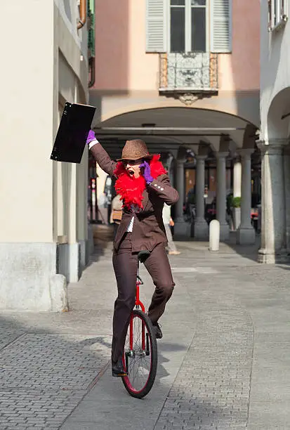woman through the city with the unicycle to go to work, outdoor
