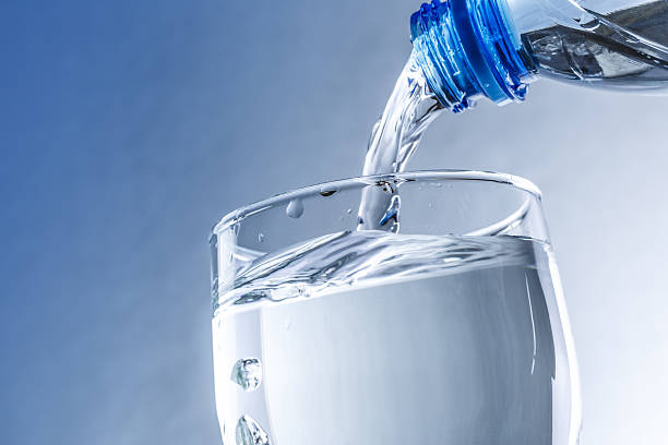 istock Pouring water from bottle into glass 481171592