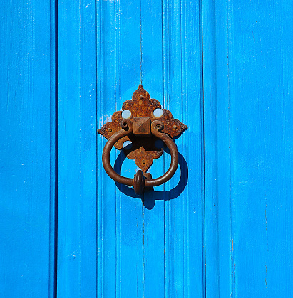 Old style knocker on wood door