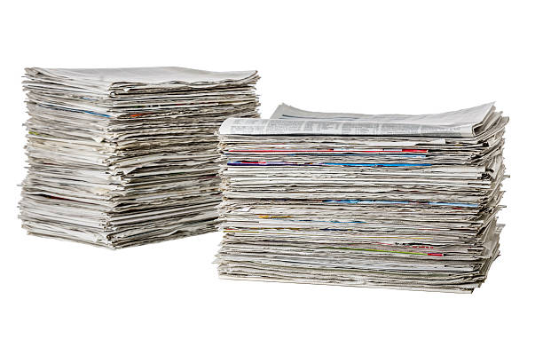 istock Two piles of newspapers on a white background 481174834