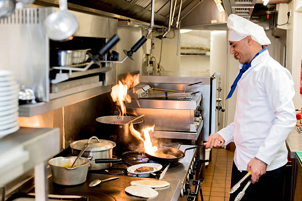 istock Male chef cooking with burning flames 481175560