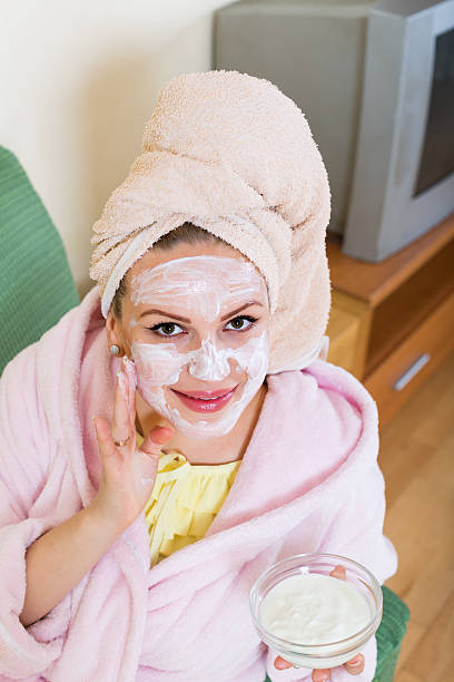 istock woman  putting cosmetic treatment on face 481175676