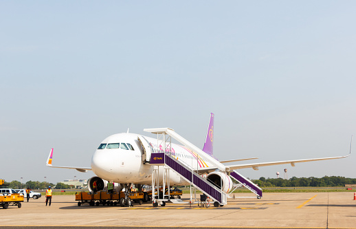 Ubonratchathani, Thailand - June 5, 2015: Thai Smile plane loading baggage and waited fly at Ubonratchathani airport.