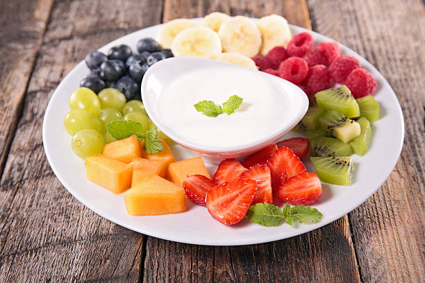 fruits and yogurt dip fruits and yogurt dip dipping sauce stock pictures, royalty-free photos & images