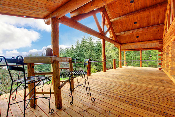 istock Porch of  log cabin with small table and forest view. 481182155