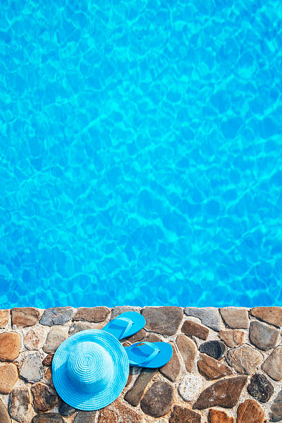 istock Blue  hat  and flip flop by a swimming pool 481183300