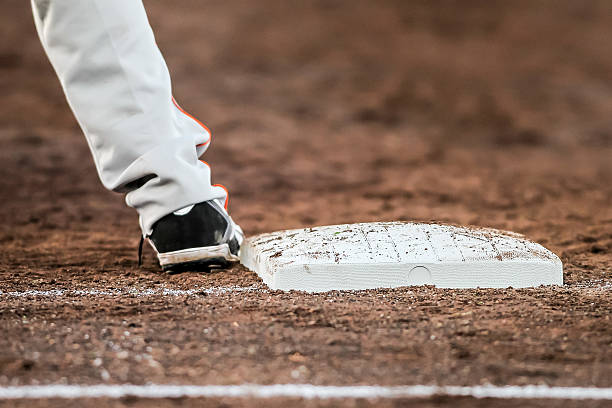 istock Baseball player with he's feet touching the base plate 481184064