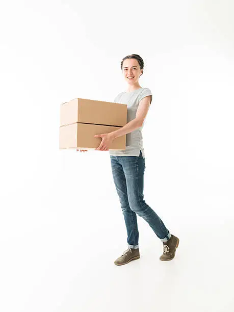 young cauacsian woman carrying moving boxes, on white background