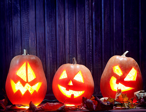 istock Jack o lanterns  Halloween pumpkin face on wooden background 481187470