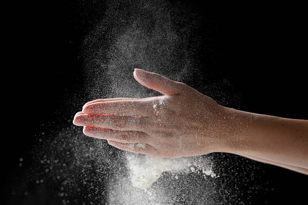 istock woman coating her hands in powder chalk magnesium 481187730